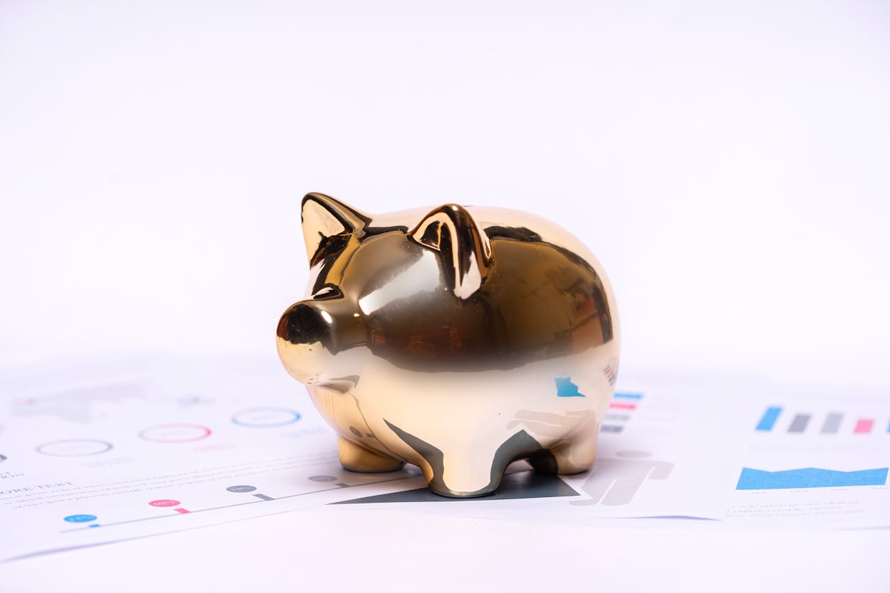 home-services-02 Close-up of a golden piggy bank on financial documents, symbolizing savings and investment.